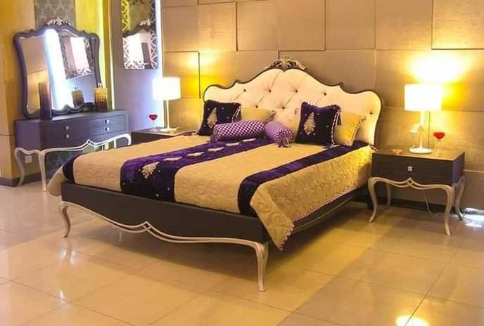 Luxury bed set with tufted headboard, dressing table and purple bedding